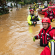 Members of the New Market Volunteer Fire Company perform a secondary search during an evacuation effort following a flash flood in Helmetta, New Jersey, on August 22, 2021, as a result of Tropical Storm Henri.